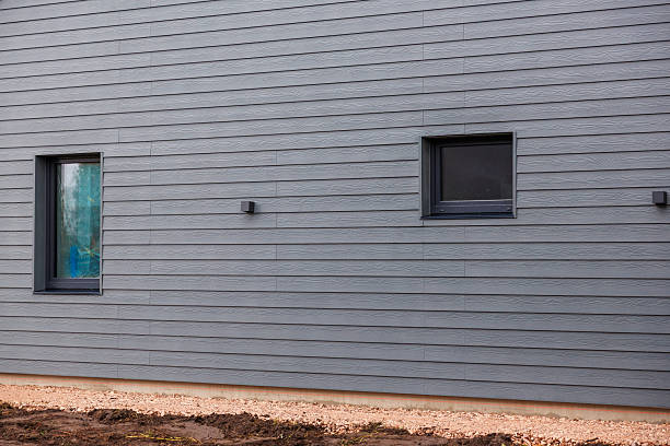 Professional contractor installing durable fiber cement siding on a house in Cincinnati