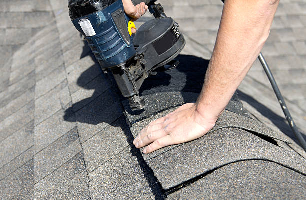 Roof maintenance and shingle repair work being performed by a contractor in Cincinnati